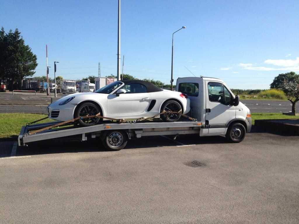 Damage car removal service towing wrecked vehicle on truck